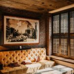 A comfy room with a wooden ceiling and brick walls