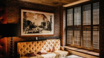 A comfy room with a wooden ceiling and brick walls