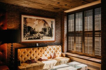 A comfy room with a wooden ceiling and brick walls
